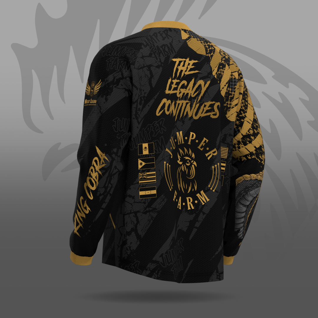 Black and gold long sleeve jersey with text and logos on a gray background